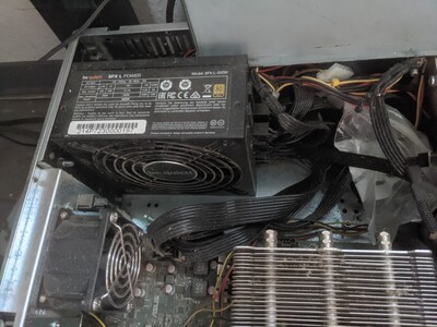 The new power supply. Fits well in height and leaves more than enough room for its modular cables (even for the ones that aren't used) and airflow.